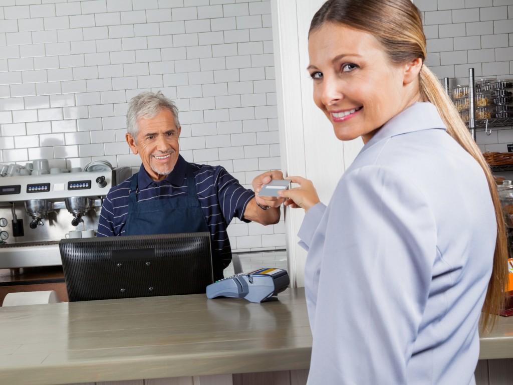 Swipe for Kidz Female Customer Making Payment Through Credit Card In Store